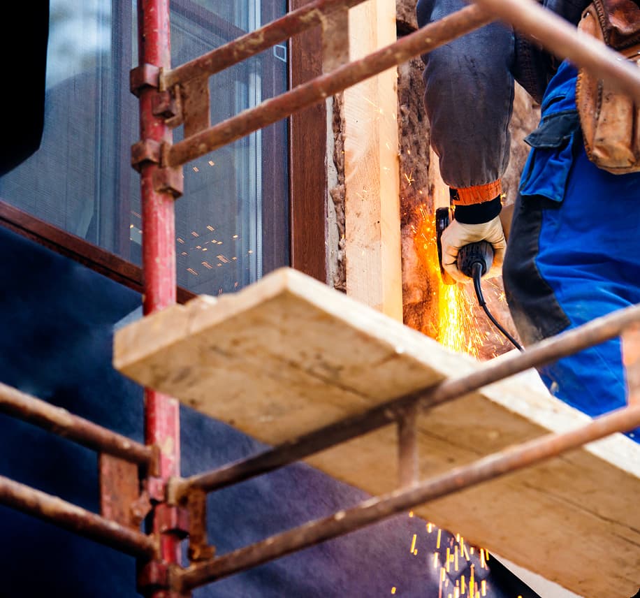 Worker cutting a wall